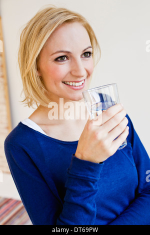 Studio portrait of young woman with glass of water Stock Photo