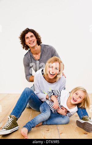 Studio shot of couple having fun with daughter Stock Photo