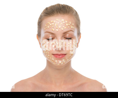 Portrait of relaxed young woman making oatmeal mask Stock Photo