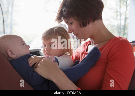 Close up of mother, baby boy and female toddler Stock Photo
