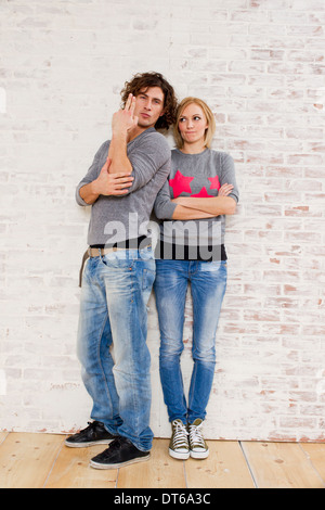 Studio portrait of couple making gun hand gestures Stock Photo