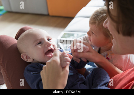 Cropped shot of mother, baby boy and female toddler Stock Photo