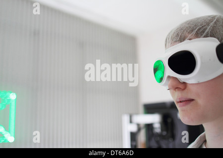 Young female scientist working in laser laboratory Stock Photo