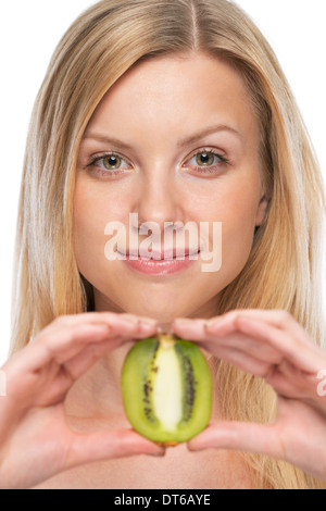 Portrait of young woman showing kiwi Stock Photo