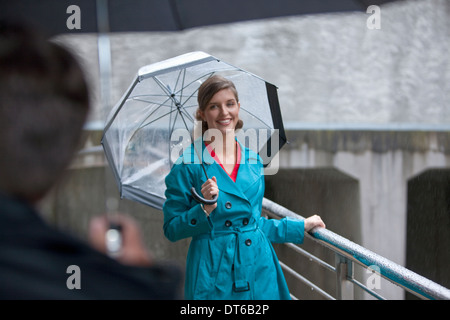 Young woman greeting mature man on footbridge Stock Photo