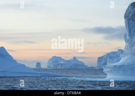 Tall sculpted pillars of ice floating in the sea in a fjord. Stock Photo