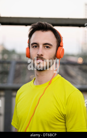 Portrait of young male runner wearing headphones Stock Photo