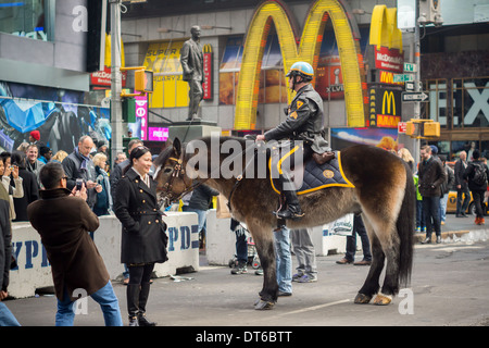 An NYPD officer entertains tourists in Times Square in New York on Sunday, February 2, 2014. (© Richard B. Levine) Stock Photo