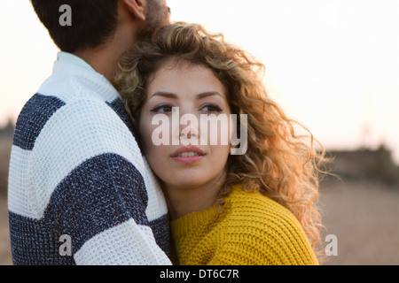 Young couple hugging on beach