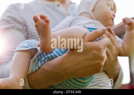 Father carrying baby daughter Stock Photo
