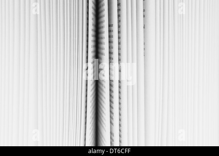 Close up of a book with the pages slightly fanned out, with a black paper edge in the centre. Stock Photo
