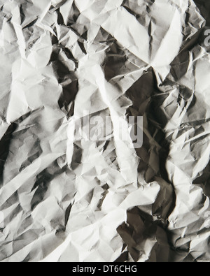 A piece of recycled white paper, crumpled and scrunched up, refuse. Stock Photo