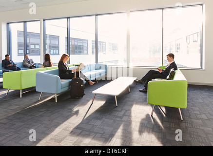 Businesspeople in departure lounge Stock Photo