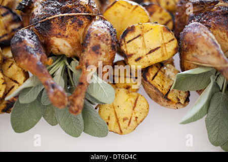 Organic free-range cooked chicken and roasted potatoes on a dish. Food for a party. Stock Photo