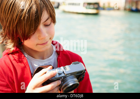 Young boy checking photographs on camera,Venice, Italy Stock Photo