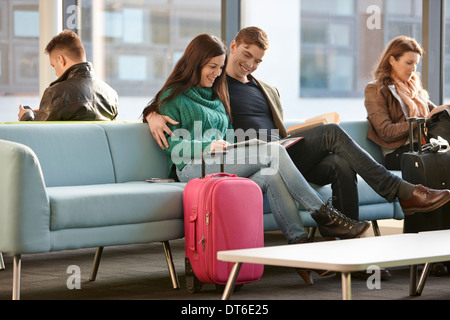 Young couple in departure lounge Stock Photo