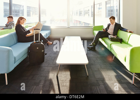 Businesspeople in departure lounge Stock Photo