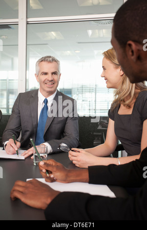Business manager and colleagues holding meeting in office Stock Photo