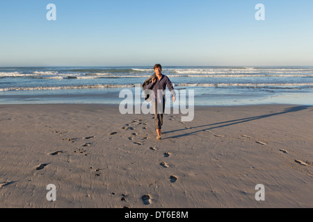 Man walking on beach Stock Photo