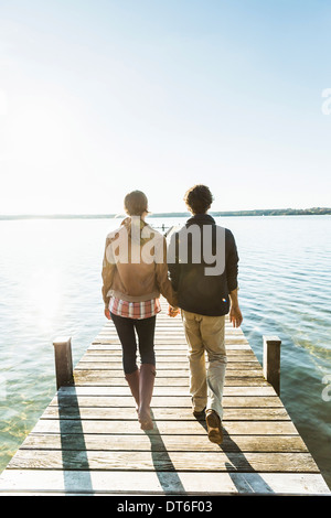 Couple on jetty, Lake Starnberg, Bavaria, Germany