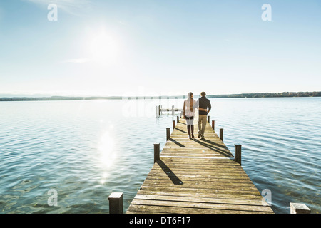Couple on jetty, Lake Starnberg, Bavaria, Germany
