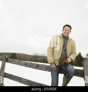 A mature man in a barn coat