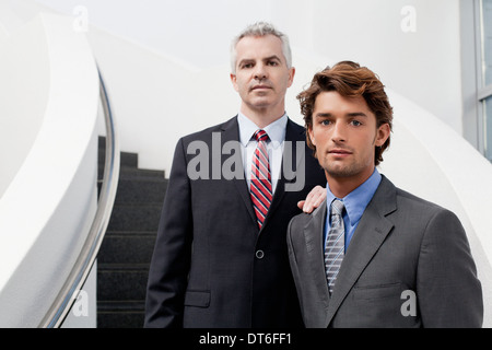 Portrait of two businessmen on office stairs Stock Photo