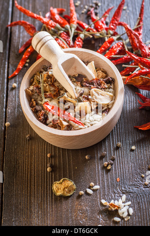 Mixture of raw rice and dried vegetables in wooden bowl on a textile background Stock Photo