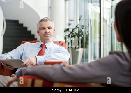 Businessman holding interview in office Stock Photo