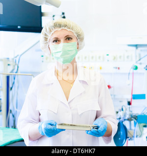 Female Surgeon Nurse In Operation Room Stock Photo
