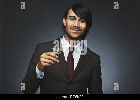Portrait of successful young businessman holding a cup of coffee. Handsome male model in business suit with coffee Stock Photo