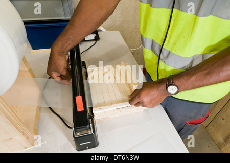 Afro Caribbean man packing goods Stock Photo