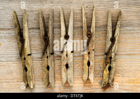 dirty old clothespins on a wooden background Stock Photo