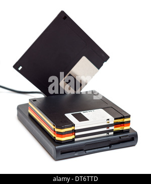 External usb floppy disk drive with disks, one standing isolated on white background Stock Photo