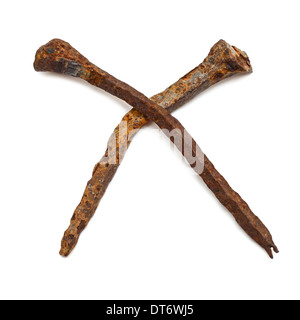 Two old hand forged rusty nails isolated on white background Stock Photo