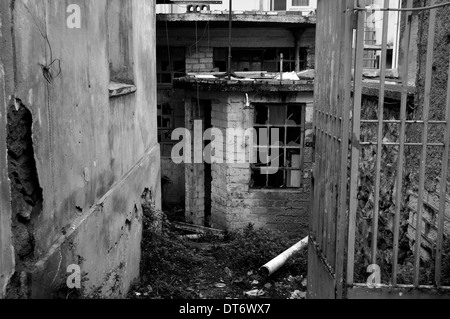 Rusty gate to an abandoned warehouse. Black and white. Stock Photo