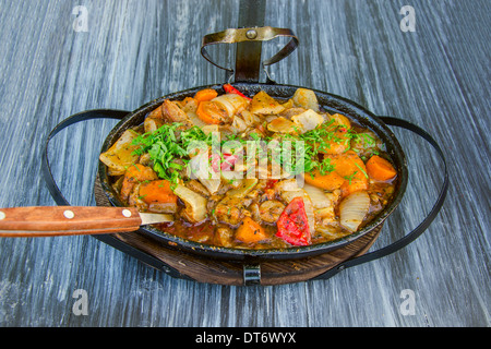 stewed meat with vegetables in a frying pan Stock Photo