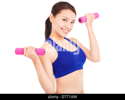 smiling woman working out with dumbbells in her hands Stock Photo