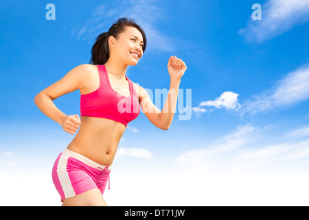 asian smiling runner woman jogging in sunny day Stock Photo