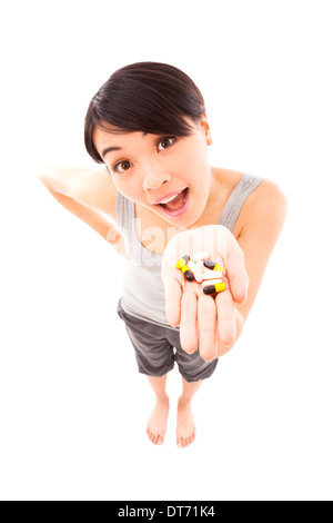 Portrait of young happy smiling woman showing vitamin Stock Photo