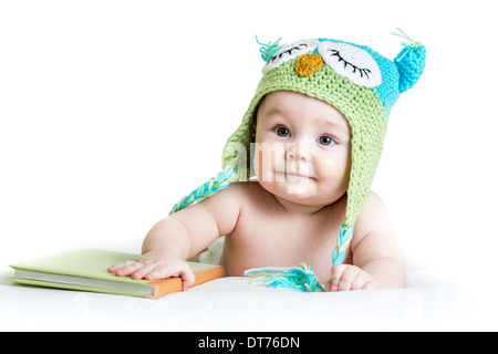 baby in funny owl knitted hat owl with book on white background Stock Photo