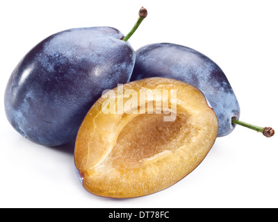 Plums with half of one isolated on a white background. Stock Photo