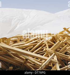 White tarp covering pile of wood 2x4 studs used for construction, near Pullman Stock Photo