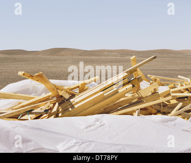 White tarp covering pile of wood 2x4 studs, farmland in background, near Pullman Stock Photo