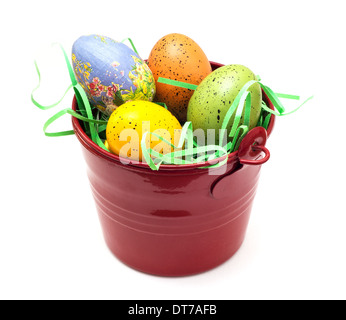 Red bucket with colorful easter eggs on a white background. Stock Photo
