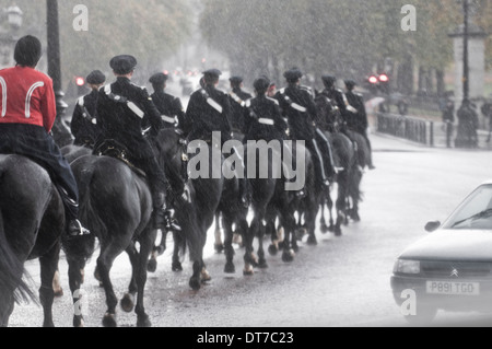 Parade by the 68 Signals Squadron riding through the torrential rain in the streets of London for 2010 Lord Mayor's Show. Stock Photo