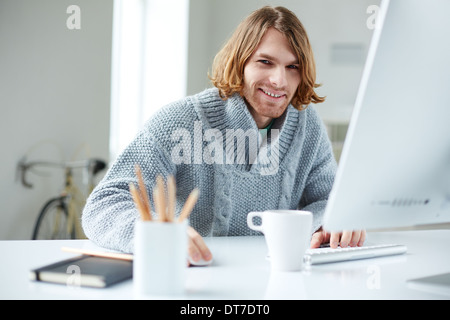 Portrait of handsome man working with computer in office Stock Photo