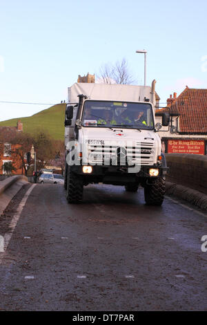 Burrowbridge, Somerset Levels, UK – 11th February 2014. The Britsh Red Cross continue to provide relief on the Somerset Levels, the Unimog vehicle is shown here crossing the bridge at Burrowbridge. The Unimog is fitted with a snorkel exhaust pipe to drive through flood water. Stock Photo