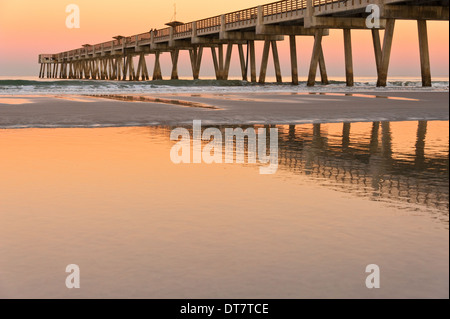 Jacksonville Beach Pier bathed in the afterglow colors of sunset in Jacksonville Beach, Florida, USA. Stock Photo