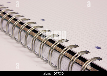 Detail of spiral notebook on white background Stock Photo